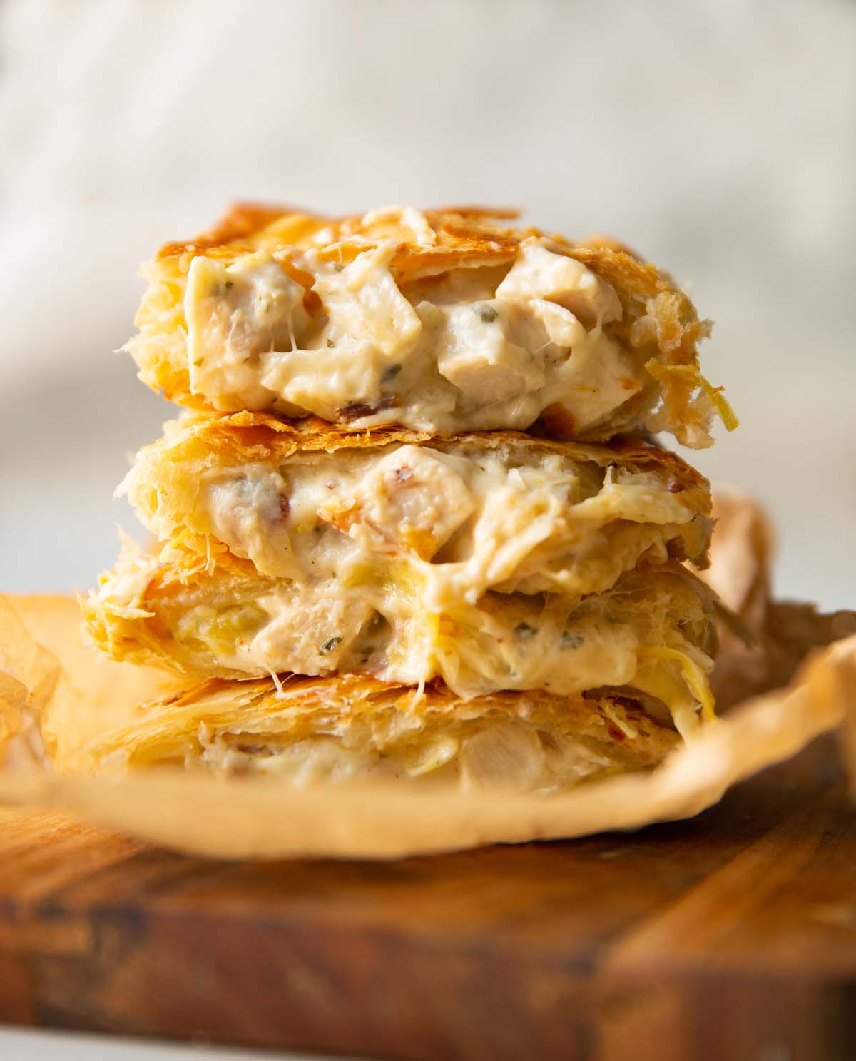 4 halved boursin bakes stacked on each other on wooden board