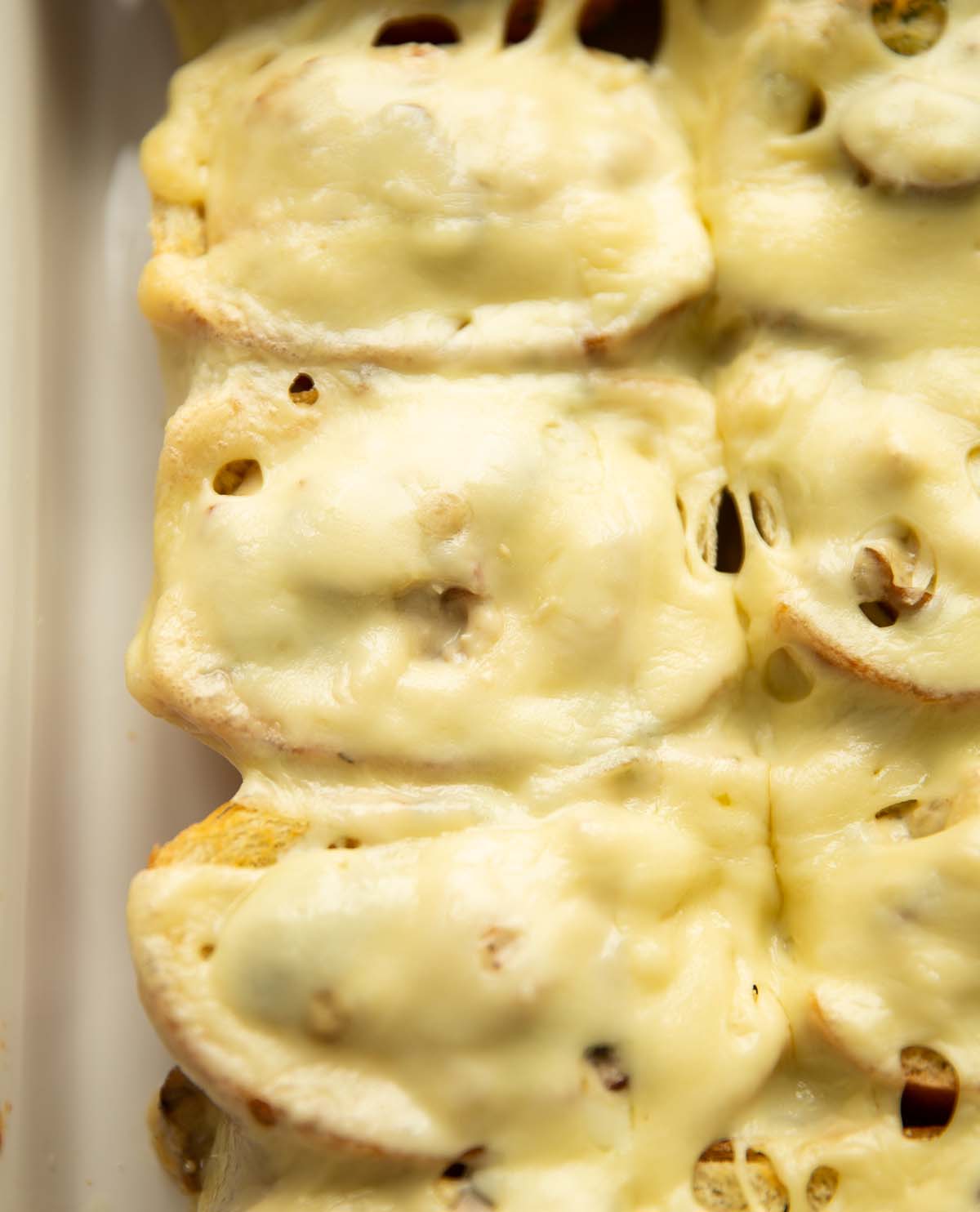 close up overhead shot of cheesy chicken sliders in baking dish fresh out the oven
